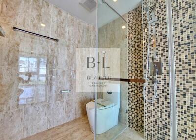 Modern bathroom with glass shower and tiled walls