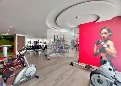 Modern fitness gym with equipment and motivational poster