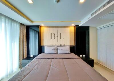 Modern bedroom with large bed and wall lighting