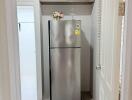 Compact modern kitchen with a stainless steel refrigerator