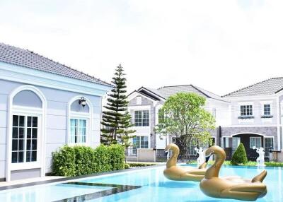 Outdoor swimming pool with inflatable swan floaties