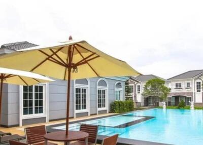 Outdoor pool area with chairs and umbrellas