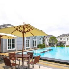 Outdoor pool area with chairs and umbrellas