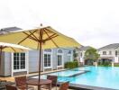 Outdoor pool area with chairs and umbrellas