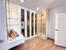 Bedroom with mirrored wardrobe and glass shelves