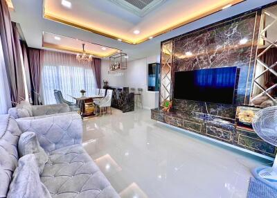 Elegant and modern living room with chandelier and marble accents