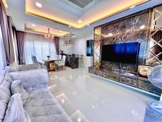 Elegant and modern living room with chandelier and marble accents