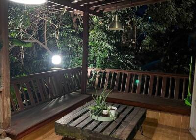 Outdoor balcony with wooden seating and table