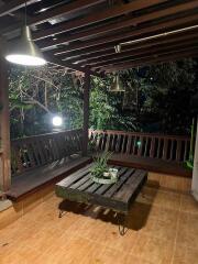 Outdoor balcony with wooden seating and table