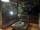 Outdoor balcony with wooden seating and table