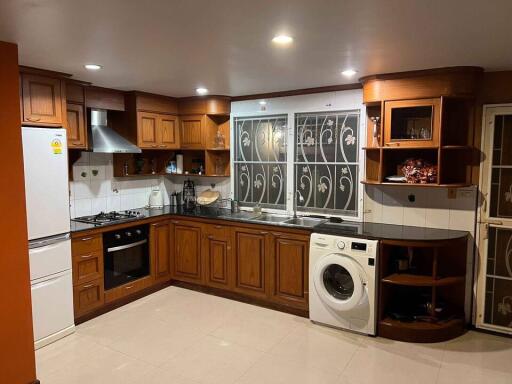 Modern kitchen with wooden cabinetry and appliances