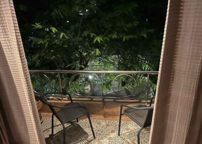 Balcony with chairs and green foliage