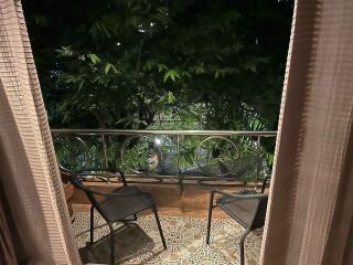 Balcony with chairs and green foliage