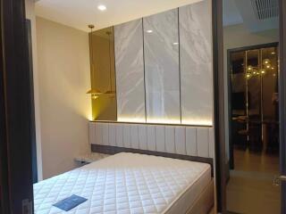 Modern bedroom with stylish headboard and lighting