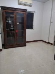 Room with glass cabinet and air conditioning unit