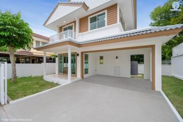 Front view of a modern two-story house with a carport