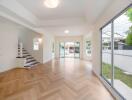 Bright and spacious main living area with large windows and wooden flooring