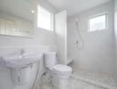 Modern bathroom with white fixtures and walk-in shower