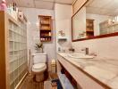 Modern bathroom with tiled walls and glass block divider