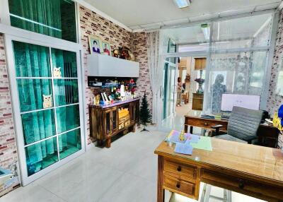 Modern home office with large glass windows and brick accent walls