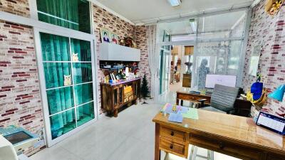 Modern home office with large glass windows and brick accent walls