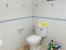 Bathroom with toilet and tiled walls