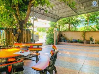 Spacious covered outdoor area with seating and greenery