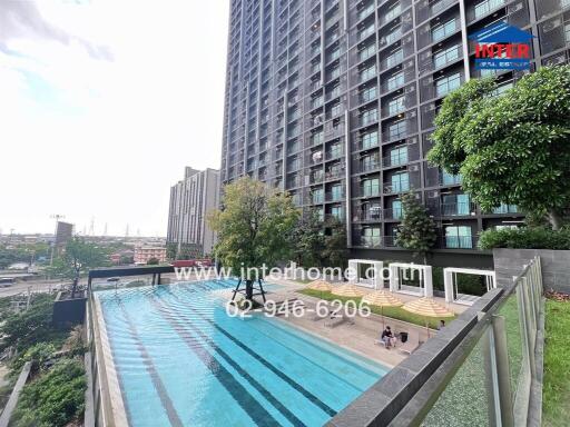 Swimming pool view with residential buildings in the background