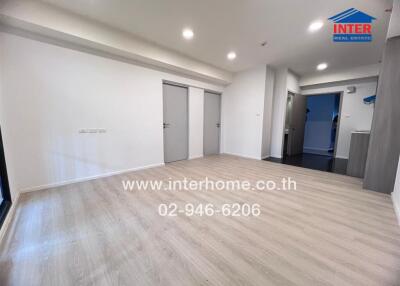 Spacious main living area with wooden floor and access to other rooms