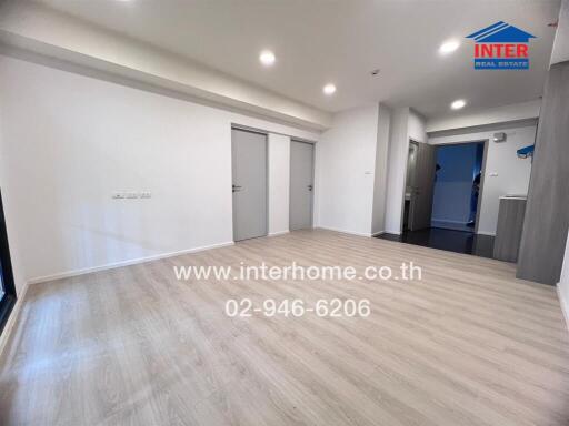 Spacious main living area with wooden floor and access to other rooms