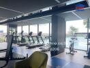 Modern gym with cardio equipment and pool view