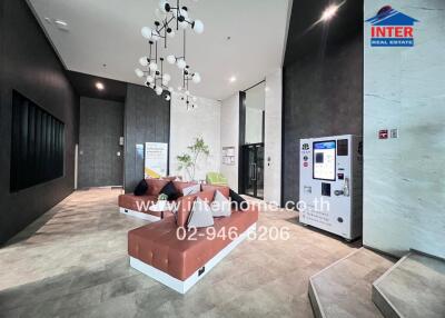 modern apartment lobby with seating area and vending machine