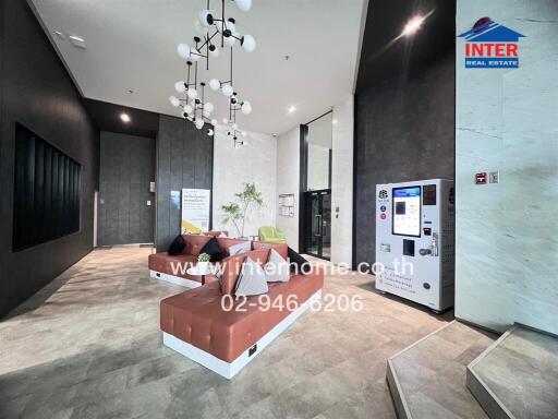 modern apartment lobby with seating area and vending machine