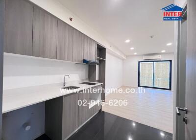 Modern kitchen with gray cabinets and open living space