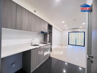 Modern kitchen with gray cabinets and open living space