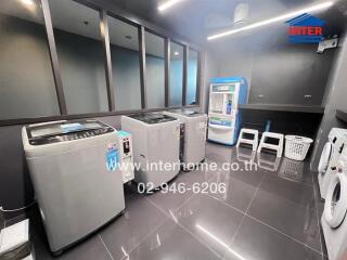 Modern laundry room with multiple washing machines and dryers