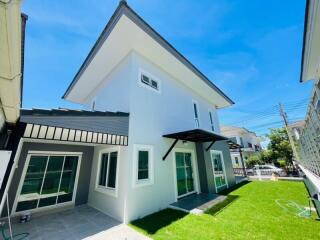 Two-story modern house with green lawn