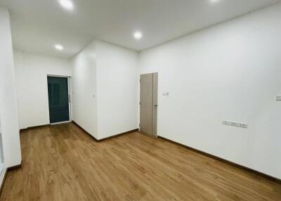 Empty room with wooden flooring and white walls