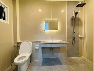 Modern clean bathroom with shower, toilet, and sink