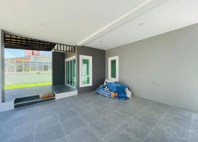 Modern open patio with tiled flooring and covered roof