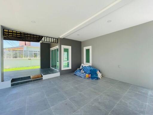 Modern open patio with tiled flooring and covered roof