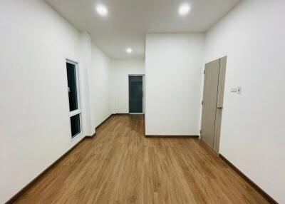 Well-lit room with wooden flooring