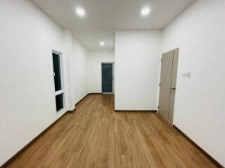 Well-lit room with wooden flooring