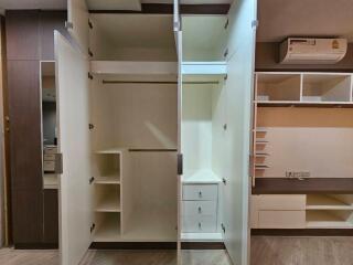 Open wardrobe with integrated shelves and storage compartments