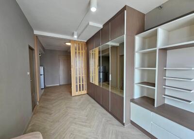 Modern living room with built-in shelving and wooden floor