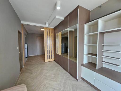 Modern living room with built-in shelving and wooden floor