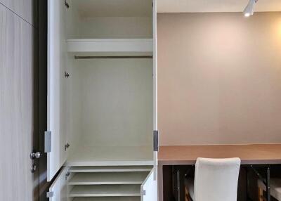 open wardrobe next to a study desk