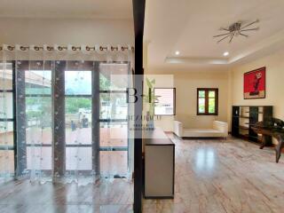 Spacious living room with large windows and modern decor