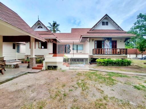 Front exterior view of a residential house with a yard