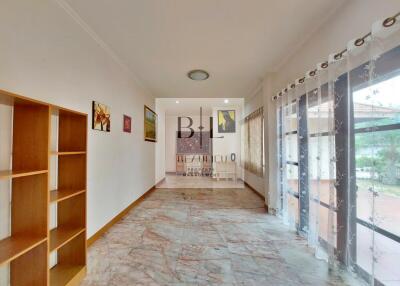 Spacious living room with tile flooring and large windows